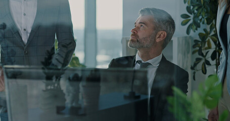 Group of multi-ethnic coworkers cooperating about new agreement consulting contract negotiating new business ideas. Teamwork. Partnership.