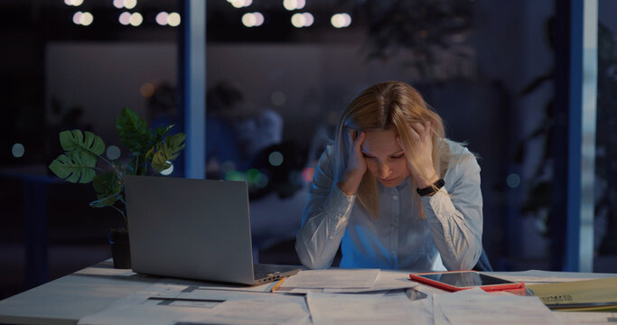 Tired young beautiful woman boss having problems at work frustrating. Exhausted office executive female overworking and feeling much stress.