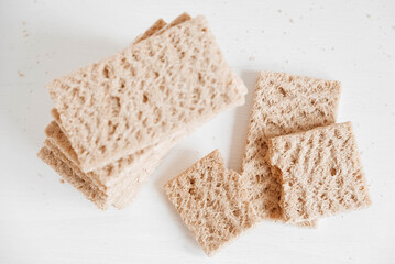 Rye crisp bread on a white wooden background. Top view. Copy, empty space for text