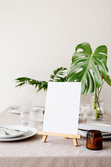 Mock up table tent, menu or stand for booklet on restaurant table with tropical bouquet