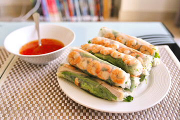 Dish of Spring rolls and sauce on the table