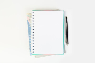 top view of an open notebook with a pen on a gray background, school notebooks with a spiral spring, office notepad. desktop concept, learning