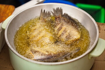 Fried dried fishs (Gourami fish) in hot oil