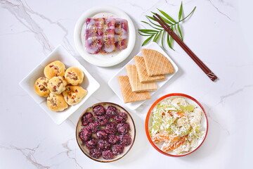 Dessert dishes on white table background (view from above)