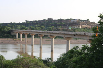 A bridge build over river with the eyecathy fort view of fort at the backside of bridge