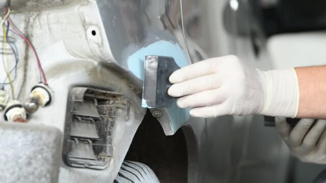 auto body repair or refinishing. Plastering the car detail before painting
