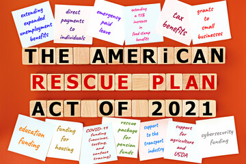 photo on The American Rescue Plan Act of 2021 theme. wooden cubes with the inscription "The American Rescue Plan Act of 2021", and sticky notes, on orange background