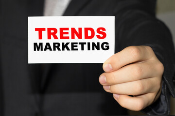 Card with text TREND MARKETING on hand. You can use in business, marketing and other concepts. Messege of the day.