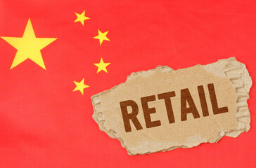 Against the background of the Chinese flag lies cardboard with the inscription - retail