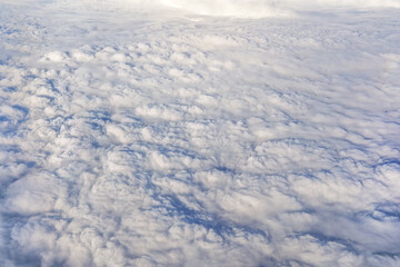Fluffy clouds that looks as flat surface as seen from commercial airplane