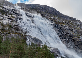 Fototapeta na wymiar Langfossen, a waterfall located in the municipality of Etne in Vestland County, Norway, Scandinavia