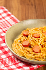 spaghetti pasta with sliced ​​sausages and tomato sauce.
