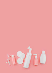 Facial cotton pad, essential oil, serum, lotion and cream 
оn pink background. Beauty and cosmetic concept.