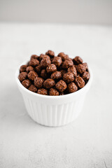 Cereal bowl with chocolate balls. Ingredient for breakfast for children, tasty food.  Crunchy and delicious meal. 