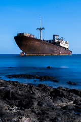 ship wreck in the sea with silk water and long exposure