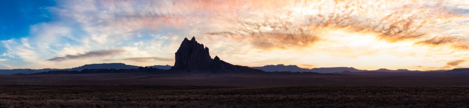 Panoramic American Nature Landscape View of the Dry Desert and Rugged Rocky Mountains. Colorful Sunset Sky Art Render. Taken at Shiprock, New Mexico, United States. © edb3_16