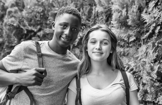 Multi Ethnic Teenager Couple Embracing In A Park