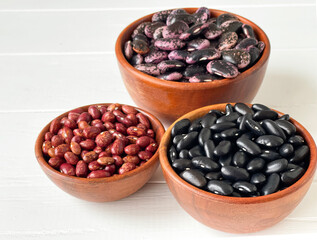 assorted colored beans in brown bowls
