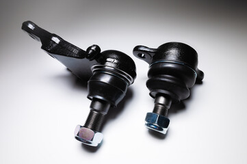 A set of two ball joints of the front suspension of a passenger car on a gray background. Service and new parts