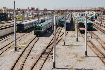 Parking for diesel electric locomotive. Vintage green train cars at the station.