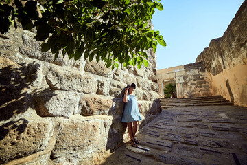 Fototapeta premium Woman Enjoying the Amazing View in Bodrum Castle. Summer Holiday in Turkey