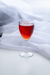 The glass of red wine or Cahors and Easter eggs on the table.