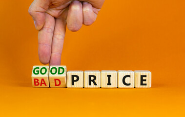 Good or bad price symbol. Businessman turns wooden cubes and changes words 'bad price' to 'good price'. Beautiful orange table, orange background, copy space. Business and good or bad price concept.