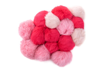 Close up of pink and red rabbit fur pompoms isolated on white background. Top view.