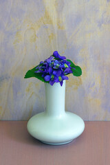 Small posy bouquet of fresh purple violet pansies