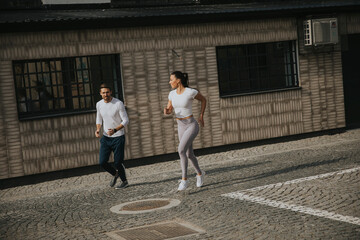 Young couple running in the urban environment