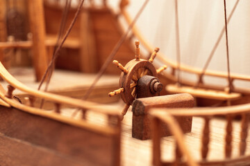 wooden steering wheel on a ship, a model of a sailboat