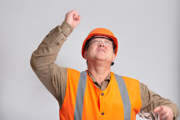 building contractor in hard hat waved his hand looking up on white isolated background, foreman controls work