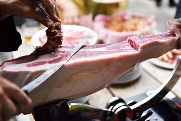 chef cutting Iberian ham with the ham knife. typical Spanish tapa