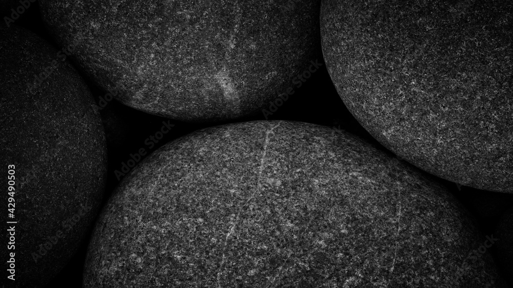 Poster dark black abstract smooth round pebbles sea texture background