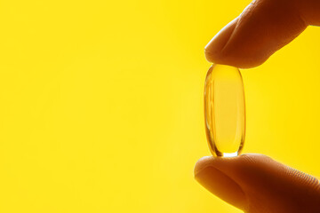 Omega 3 capsules.Vitamin drop pill capsule. Shining golden essence droplet.