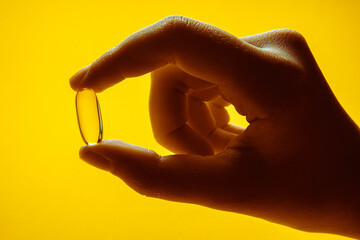 Omega 3 capsules.Vitamin drop pill capsule. Shining golden essence droplet.