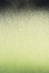 green and black spray paint on a cream colored paper background