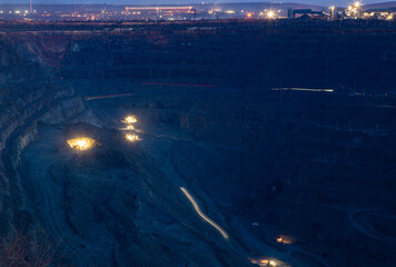 The process of iron ore mining in the quarry at night. Round-the-clock production process