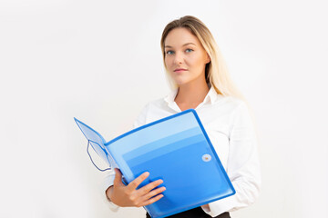 Beautiful young business woman looking at camera with blue folder in hands.