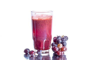 Red grape juice in glass and grape fruit isolated on white background