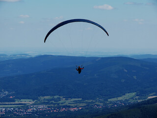 The paraglide over mountains near Karpacz in Poland