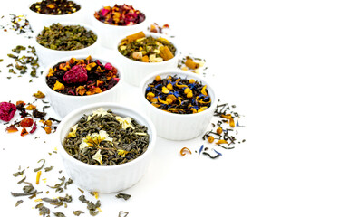 Many dry tea in bowls isolated on white background. Dried fresh dessert beverage cut out banner...
