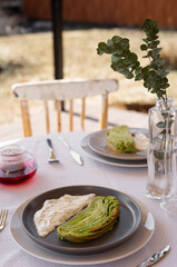 Pistachio roll is located on a plate for delicious Brunch on a summer terrace in a rustic romantic style