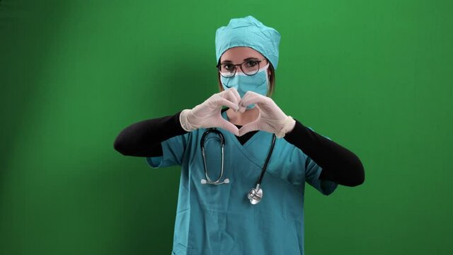 Female doctor forms the shape of a heart - studio photography