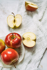 Plate with ripe multicolored apples on rustic towel.Top view.Still life.