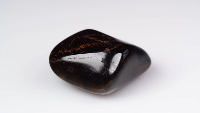 natural jaspelite gemstone on the white background on the turning table