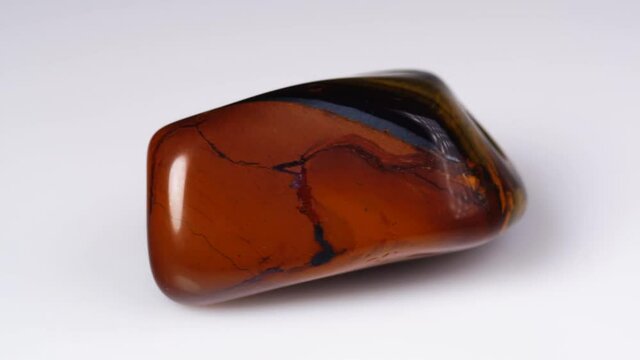 natural jaspelite gemstone on the white background on the turning table