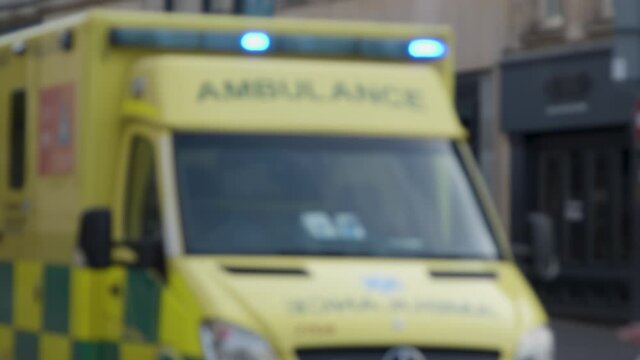 Defocused Medium Shot of Stationary Ambulance 