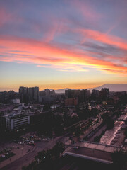 Naklejka na ściany i meble Panoramic view of beautiful and colorful clouds and sunset sky over Santiago downtown skyline and, Chile