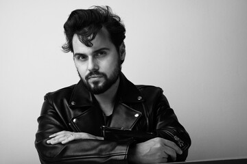 Black and white photo of bearded man. Handsome confident perfect hairstyle man.